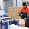 A worker in a cold storage facility uses the Viastore WMS via radio frequency for paperless picking.