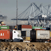 Semi trucks hauling a containers leave the Port of Los Angeles on Monday, Feb. 23, 2015. Nearly all West Coast seaports began the week with dockworkers hustling to load and unload cargo ships that were held up amid a months-long labor-management dispute.