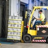 Man Riding A Yellow Forklift With Boxes 1267324