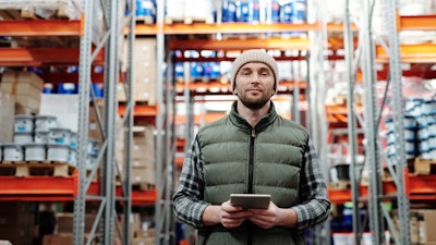 Man In Bubble Jacket Holding Tablet Computer 4484078