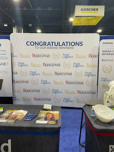 The backdrop of our booth for our awards winners.