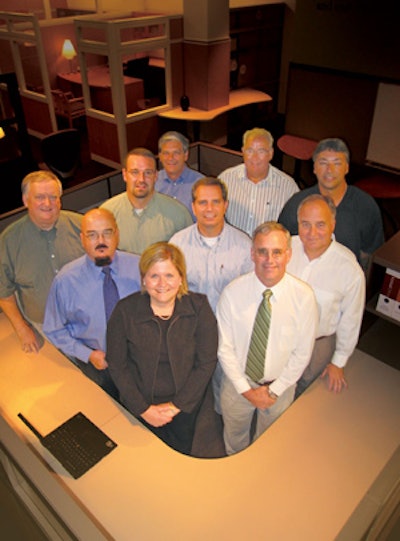 The Sourcing Team at Kimball's International Office: 1st row (left to right) — Jane Vogler, John Barwe 2nd row — Glynn Staten, Bob Price, Ben Russell 3rd row — Myron Lampert, Rob Young, Stan Schneider, Werner Bender, Larry Quade Missing from photo: Lara Dickerson