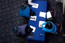 In this Wednesday, Jan. 22, 2014, photo, job seekers line up to sign in before meeting prospective employers at a career fair at a hotel in Dallas. The Labor Department releases employment data for February, on Friday, March, 7, 2014. (AP Photo/LM Otero)