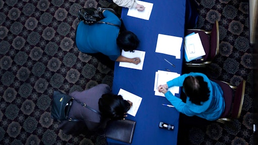 In this Wednesday, Jan. 22, 2014, photo, job seekers line up to sign in before meeting prospective employers at a career fair at a hotel in Dallas. The Labor Department releases employment data for February, on Friday, March, 7, 2014. (AP Photo/LM Otero)