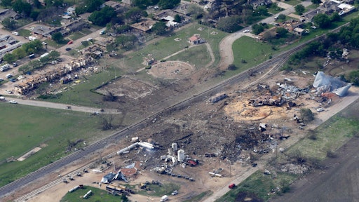 This April 18, 2013 file photo shows an aerial view of the remains of a fertilizer plant and an apartment complex to the left, destroyed by an explosion in West, Texas. The government has failed to inspect virtually all of the chemical facilities that it considers to be at high risk for a terror attack, numbering in the thousands, and has underestimated the threat to densely populated cities, congressional investigators say. (AP Photo/Tony Gutierrez, File)