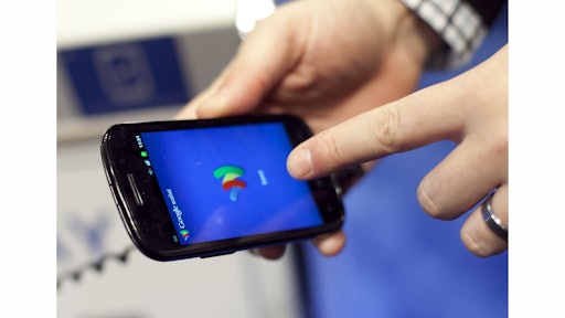 FILE - In this Jan. 17, 2012 file photo, a person tries a smartphone loaded with Google Wallet at the National Retail Federation in New York. Apple Pay has gotten a lot of attention in recent weeks, but there are lots of other mobile-payment systems. Google Wallet uses a similar wireless technology called NFC, or near-field communication. (AP Photo/Mark Lennihan, File)