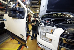 In this Nov. 6, 2014 photo, Shawn Ebeler works on the door assembly on a new Ford F-150 truck is assembled at the Dearborn Truck Plant in Dearborn, Mich. It’s Ford Motor Co.’s biggest bet in decades: an aluminum-sided F-150 that could set a new industry standard _ or cost the company its pickup truck crown. (AP Photo/Carlos Osorio)