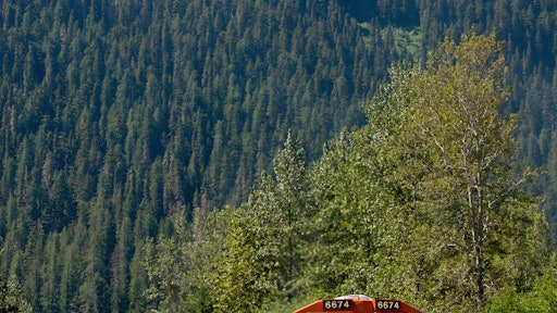 BNSF No. 6674 leads a double-stacked intermodal container train through mountains in the Scenic Subdivision in Washington state. Each double-stack intermodal train can take 280 trucks off the highways, resulting in lower emissions and fuel consumption. A BNSF train can haul one ton of freight 500 miles on one gallon of diesel fuel.
