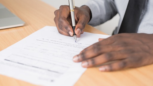 Person Holding Gray Twist Pen And White Printer Paper On 955389