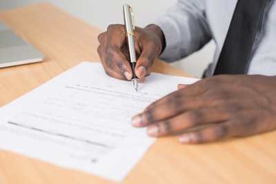 Person Holding Gray Twist Pen And White Printer Paper On 955389