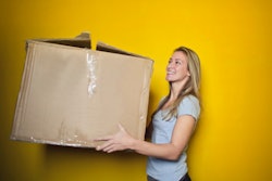 Woman In Grey Shirt Holding Brown Cardboard Box 761999