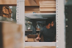 Man Under A Bunch Of Large Shelves 1797415