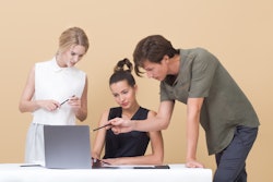 Two Woman And One Man Looking At The Laptop 1036641