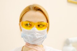 Woman In White Scrub Suit And Yellow Goggles 3958139