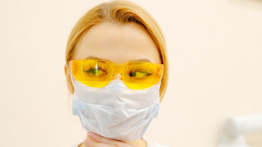 Woman In White Scrub Suit And Yellow Goggles 3958139