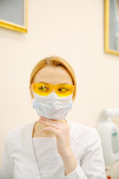 Woman In White Scrub Suit And Yellow Goggles 3958139