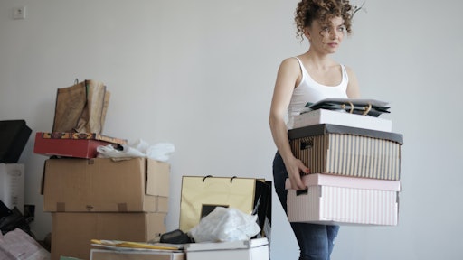 Concentrated Woman Carrying Stack Of Cardboard Boxes For 3791617