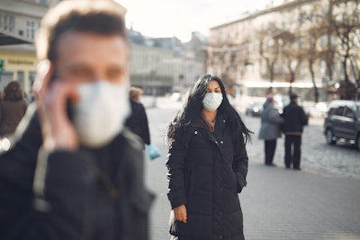 Woman In Black Coat And Face Standing On Street 3983428