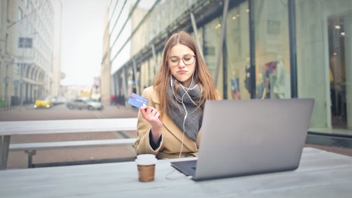 Woman In Brown Coat Holding A Bank Card 3784391