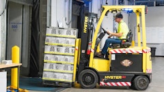 Man Riding A Yellow Forklift With Boxes 1267324