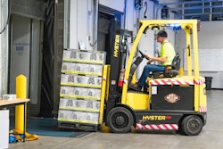 Man Riding A Yellow Forklift With Boxes 1267324