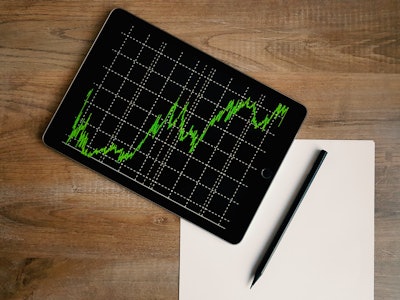 Space Grey Ipad Air With Graph On Brown Wooden Table 187041