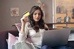 Woman Holding Card While Operating Silver Laptop 919436
