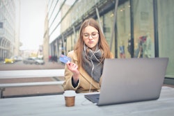 Woman In Brown Coat Holding A Bank Card 3784391