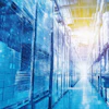 Futuristic blue-toned data center with illuminated server racks and bright central corridor
