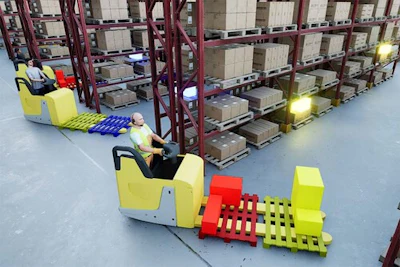 Warehouse facility with yellow and red forklifts operating near burgundy pallet racks stacked with cardboard boxes.