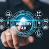 Businessman touching holographic Industry 4.0 interface with connected technology icons