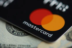 Mastercard credit card displayed on US dollar bills