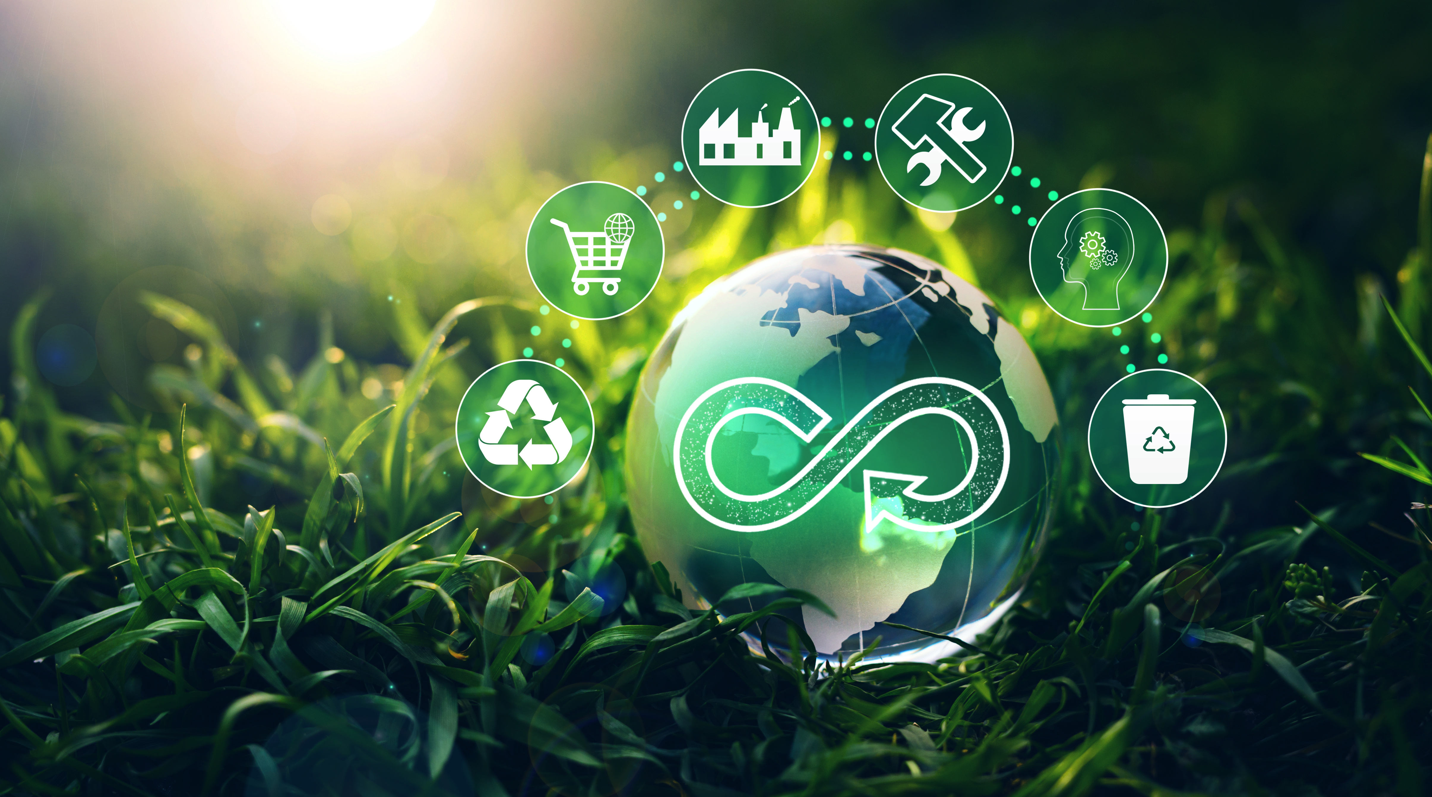 Circular economy concept with globe surrounded by sustainability icons including recycling, shopping, waste management, and renewable energy in natural green setting