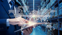 Businessman holding tablet in warehouse with holographic world map and global network visualization overlay