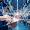 Businessman holding tablet in warehouse with holographic world map and global network visualization overlay