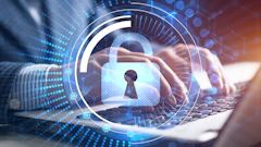 Digital security concept with glowing padlock and keyhole overlay on laptop keyboard with blue data visualization elements
