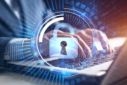 Digital security concept with glowing padlock and keyhole overlay on laptop keyboard with blue data visualization elements