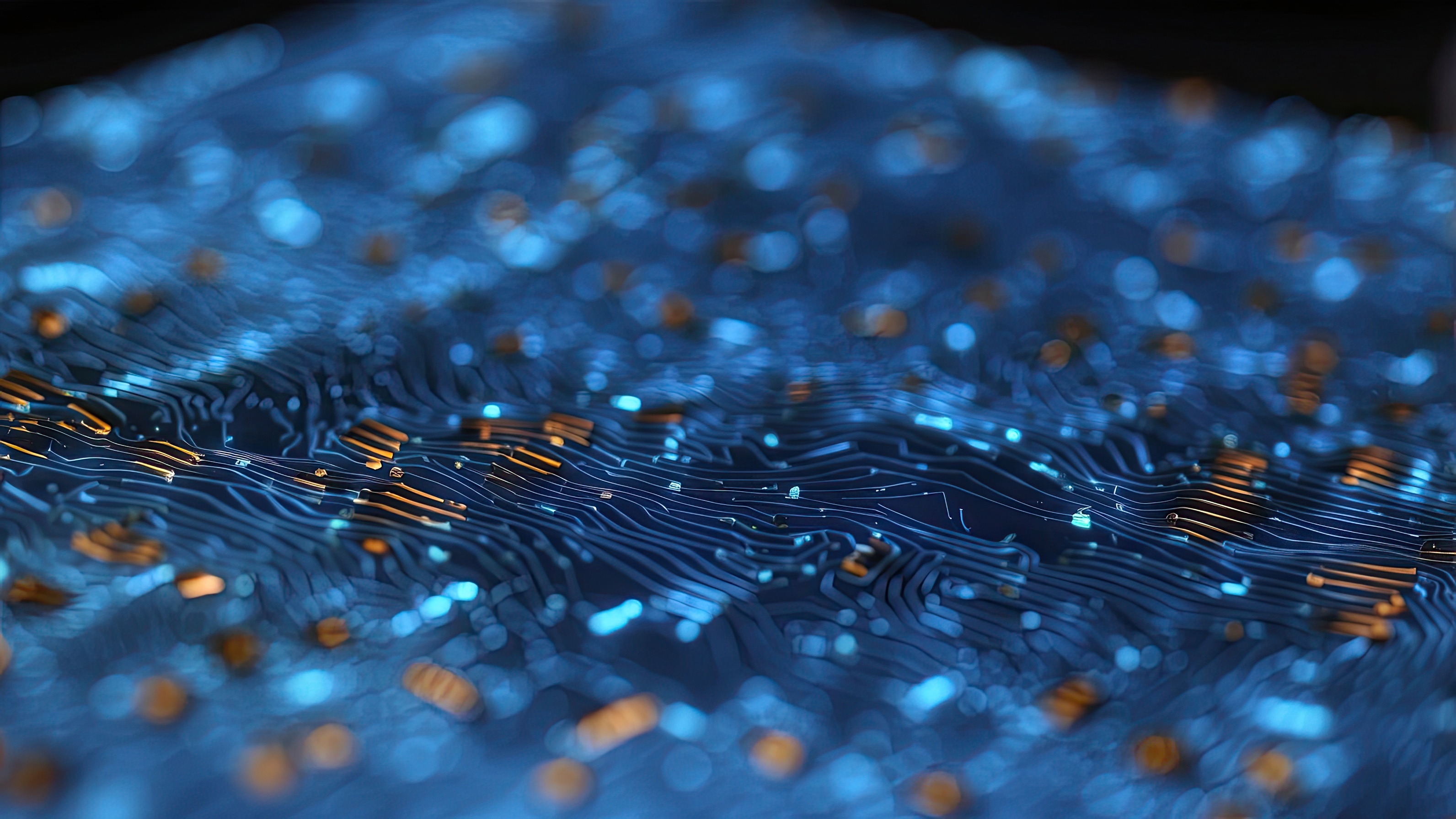 Abstract blue and orange digital particles flowing across circuit board lines with shallow depth of field effect