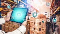 Warehouse worker holding tablet with digital logistics and supply chain management icons overlay