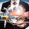 Businessman holding global logistics network with cargo ship, train, and delivery truck icons