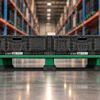 IFCO green plastic pallet with server equipment in warehouse with orange racking