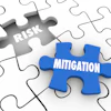 Gray and blue puzzle pieces with 'Risk' and 'Mitigation' text representing business risk management concept