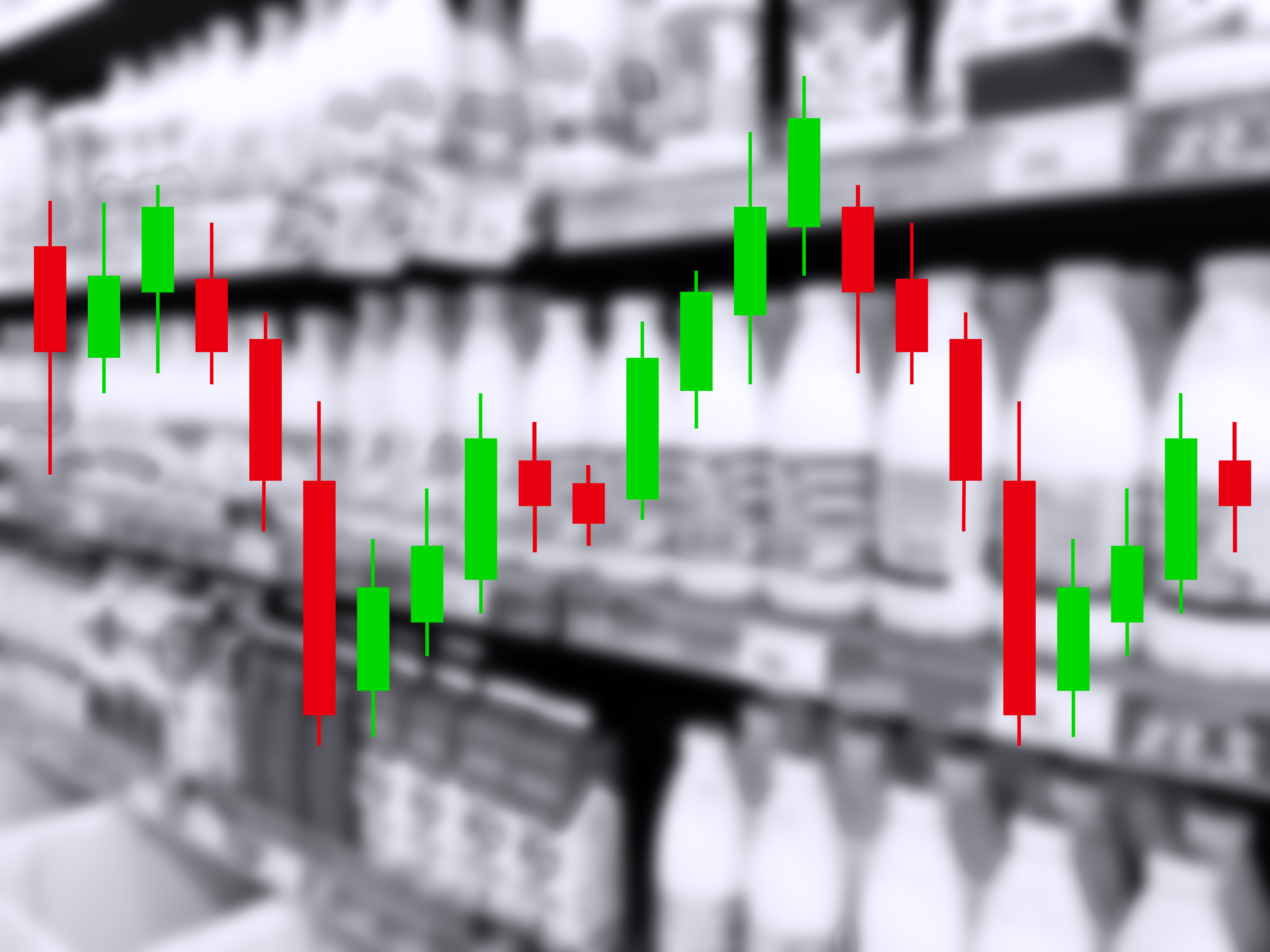 Candlestick chart with red and green bars showing financial market price movements overlaid on industrial warehouse background