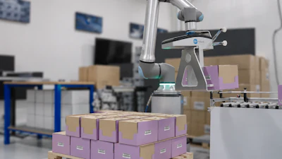 Collaborative robot arm sorting purple and brown cardboard boxes in a warehouse facility