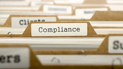 Compliance folder tab in a filing system with tan folders and white labels