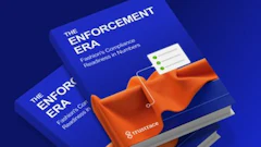Two blue 'Enforcement Era' books displayed with orange fabric on blue background